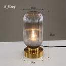 Nordic Amber table lamp featuring a stained glass shade in gray, with a metal base and aluminum details, illustrating both transparency and composite materials.