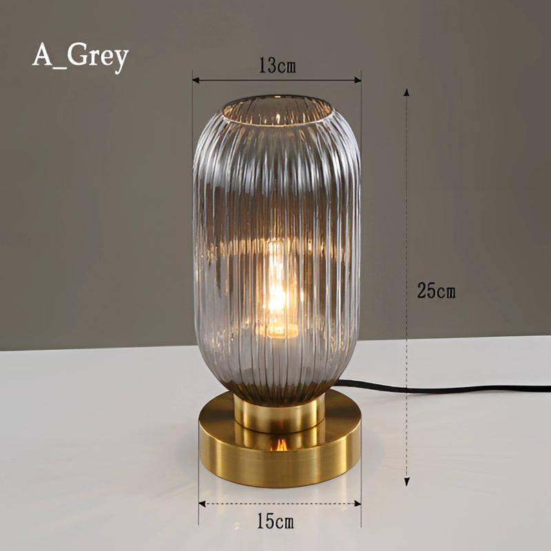 Nordic Amber table lamp featuring a stained glass shade in gray, with a metal base and aluminum details, illustrating both transparency and composite materials.