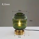 Nordic Amber Table Lamp featuring a stained glass shade with green accents, showcasing artistic and symmetrical design elements.