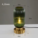 Nordic Amber table lamp featuring a stained glass shade in shades of green, with a sleek metal base crafted from aluminium and titanium.
