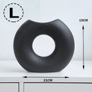 Large black Nordic style ceramic donut vase with a modern circular design for office and living room decor.