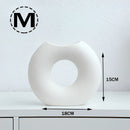White Nordic style ceramic donut vase featuring a modern circular design, ideal for office and living room decor.