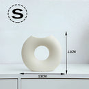 Nordic style ceramic donut vase featuring a modern circular design, ideal for office and living room decor.