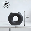 Small black Nordic style ceramic donut vase featuring a modern circular design, ideal for office and living room decor.
