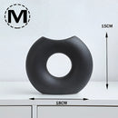 Black Nordic style ceramic donut vase featuring a modern circular design, ideal for office and living room decor.