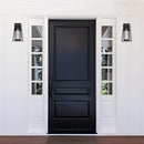 Outdoor wall lantern sconce made of black steel with glass panels, IP44 waterproof, installed beside a wooden door with a handle.