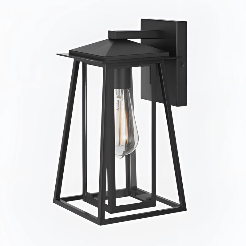 Black steel IP44 waterproof outdoor wall lantern sconce with glass panels mounted on a wall, surrounded by outdoor furniture.