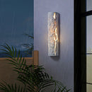 Outdoor wall light with IP65 waterproof rating, featuring a premium resin faux rock finish, displayed among plants with a rectangular, glass-covered design and wood accents.