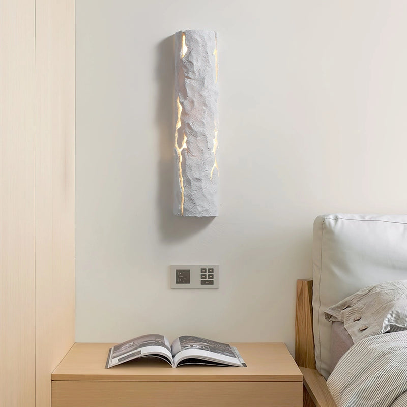 Outdoor wall light with IP65 waterproof rating, featuring a premium resin faux rock finish, displayed against a wooden background with hardwood flooring.