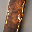 Outdoor wall light featuring IP65 waterproof rating with a premium resin faux rock finish, designed to resemble a sculpture with amber tints and shades.