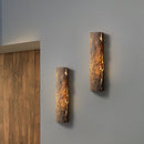 Outdoor wall light featuring a premium resin faux rock finish in brown, designed to resemble hardwood and metal, with amber tints and shades, IP65 waterproof.