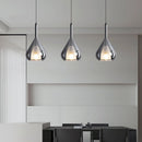 Nordic style pendant lamp featuring a clear raindrop design with a starlight effect, hanging from a ceiling with a wooden shade and grey floor background.