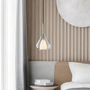 Nordic style pendant lamp featuring a clear raindrop design with a starlight effect, complemented by a grey shade and wooden elements in a cozy interior setting.