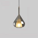 Smoke gray pendant lamp in a Nordic style featuring a clear raindrop design with a starlight effect, displayed over a wooden table.