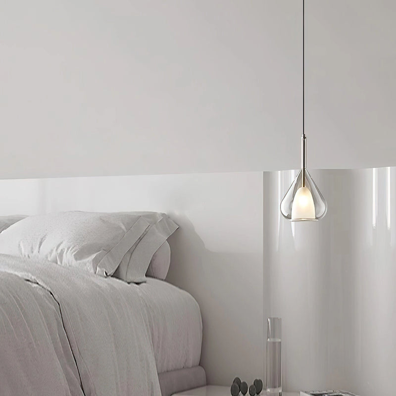 Nordic style pendant lamp featuring a clear raindrop design with a starlight effect, set against a grey interior with wooden elements.