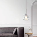 Nordic style pendant lamp featuring a clear raindrop design with starlight effect, displayed in an interior with grey tones and wooden elements.