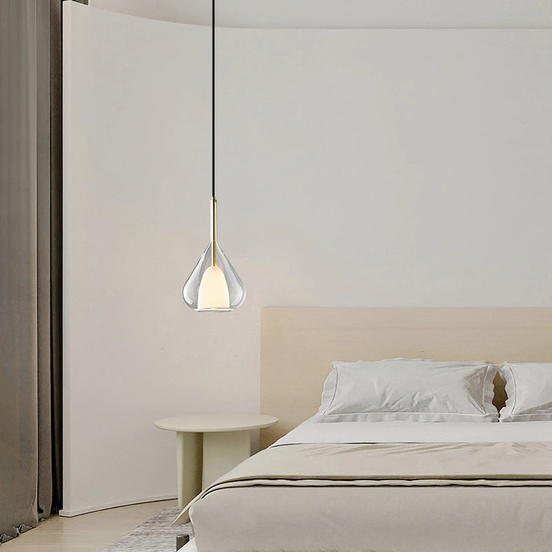 Nordic style pendant lamp featuring a clear raindrop design with a starlight effect, set against a grey interior with wooden elements.