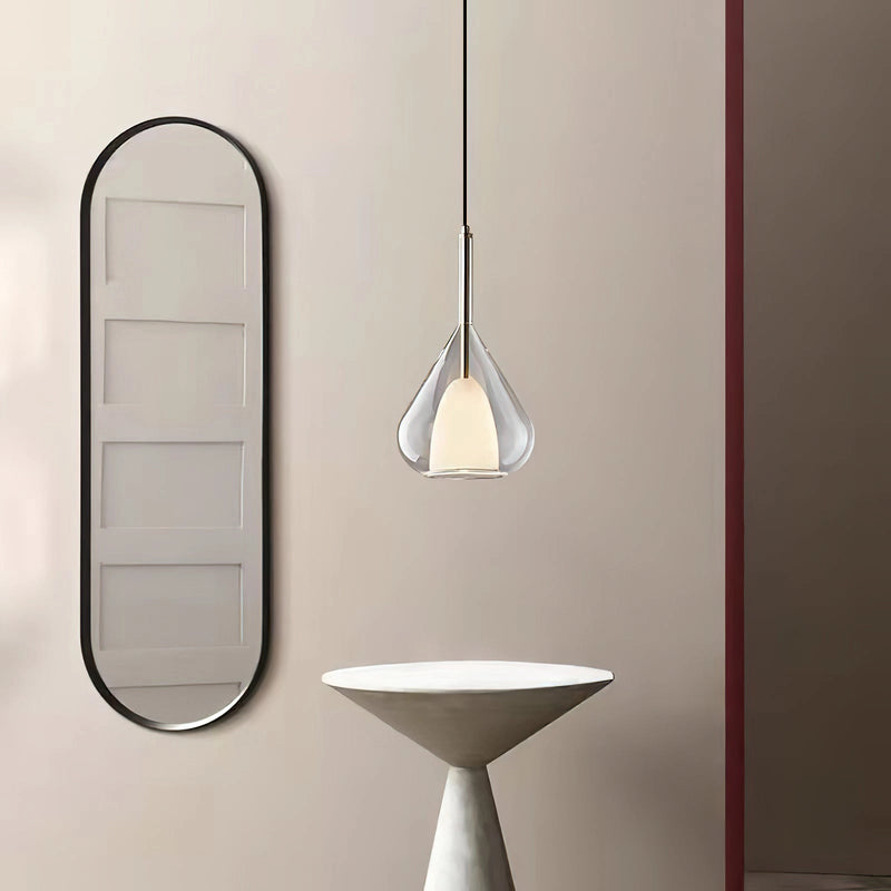 Clear glass pendant lamp featuring a raindrop design with a starlight effect, crafted from metal and composite materials in a Nordic style, hanging from the ceiling.