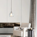 Nordic style pendant lamp featuring a clear raindrop design with a starlight effect, displayed over a grey couch in a stylish living room setting.