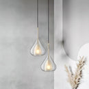 Clear raindrop-design pendant lamp featuring a starlight effect, crafted in a Nordic style with elements resembling twigs and natural materials, suspended as a chandelier.