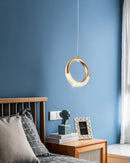 Modern Dante Pendant Lamp featuring a rectangular azure blue chandelier with wooden accents, set against a mirrored backdrop in an elegantly designed interior.