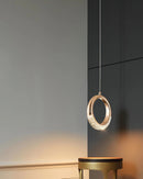 Modern Dante Pendant Lamp featuring a chandelier design with wooden and metal elements, incorporating rectangular and circular shapes, set against a backdrop with varied tints and shades.