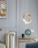 Modern Dante Pendant Lamp chandelier hanging in a stylish living room with a studio couch, wood elements, and elegant interior design.