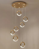 Amber and wood pendant lamp Dante styled as a modern chandelier, featuring a circular design with metal accents, rectangular elements, and a ceiling fixture.