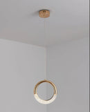 Modern Dante Pendant Lamp featuring a beige oval and circular wood design with rectangular accents, styled as a ceiling fixture.