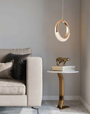 Modern chandelier Dante pendant lamp displayed over a beige couch and a wooden table in a stylish interior with grey and beige tones.
