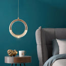 Modern Dante pendant lamp chandelier hanging over a wooden table surrounded by a comfortable couch and aqua dishware in an azure-themed interior design setting.