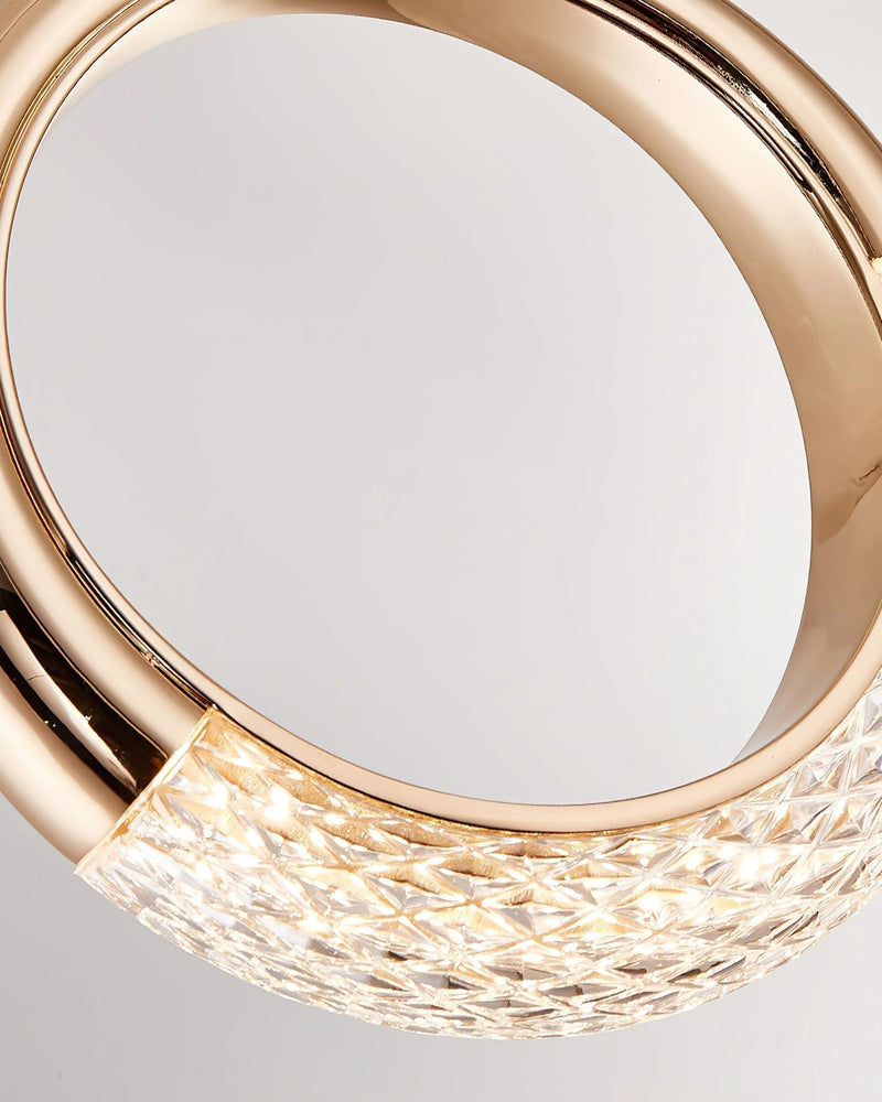 Modern Dante Pendant Lamp featuring a chandelier design with circular glass and metal elements, resembling dishware and jewelry aesthetics.