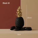 Golden resin ornament designed in the shape of a pineapple, featuring a black medium variant, for Nordic home decor.