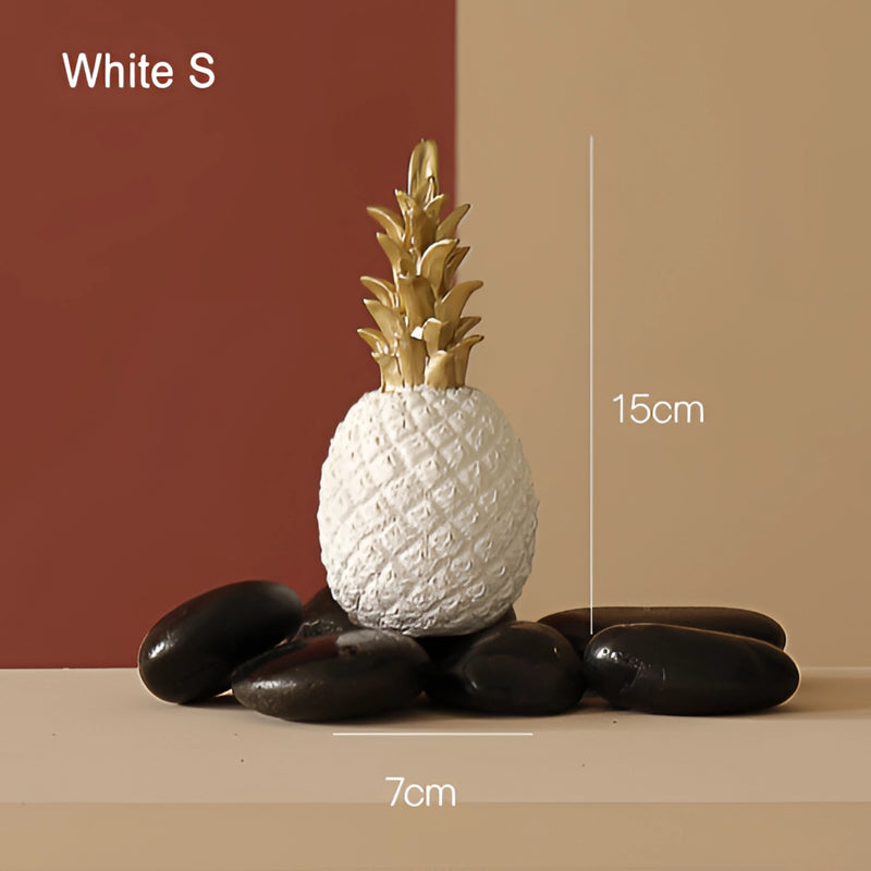 Golden resin ornament shaped like a pineapple, displayed in a white flowerpot, featuring natural wood elements.