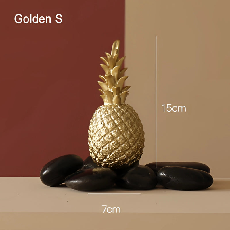Golden resin ornament in the shape of a pineapple for home decor, displayed in a flowerpot, emphasizing its detailed texture and naturalistic design.