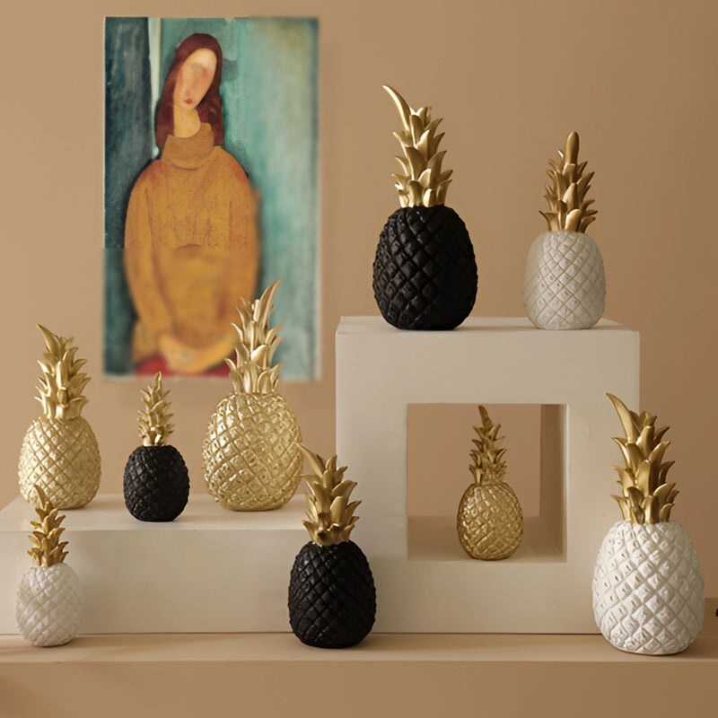Golden resin pineapple-shaped ornament for Nordic home decor displayed on a rectangular base, showcasing artistic and collectible qualities in a still life setting.