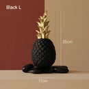 Golden resin ornament in the shape of a pineapple, designed for Nordic home decor, displayed on a rectangular base.