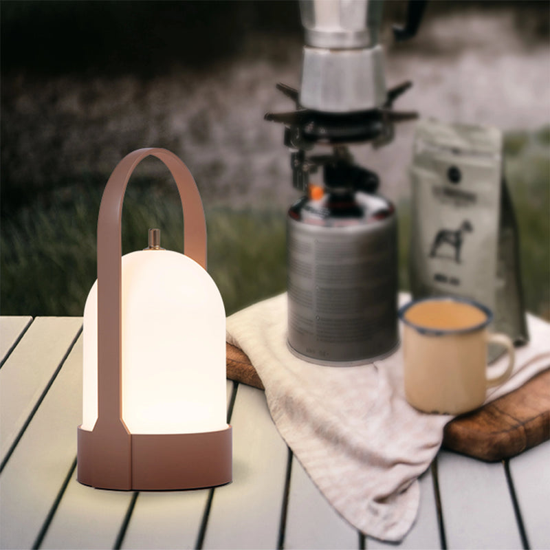 Rechargeable table lamp with touch dimming feature, displayed on a wooden table, emphasizing its elegant design and ambient lighting.