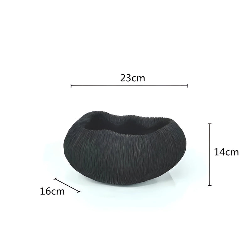 Decorative bowl inspired by nature, designed with intricate textures and shapes resembling natural elements, not clearly depicted in the image.