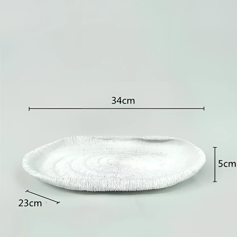Oval resin decorative bowl inspired by nature, featuring a textured surface that resembles synthetic rubber, displayed against a ceiling background with metal fixtures.