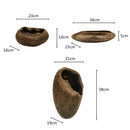 Decorative resin bowl inspired by nature, featuring an intricate design that includes elements resembling plants and trees, with detailed illustrations suggestive of eyes and faces.