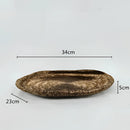 Decorative resin bowl inspired by nature, featuring intricate metal and natural material embellishments, shaped in an oval with artistic illustrations.