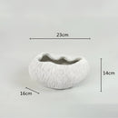 Decorative resin bowl inspired by nature, featuring intricate human facial features including eyes, eyelashes, and jaw, highlighted by artistic gestures and cosmetic details.