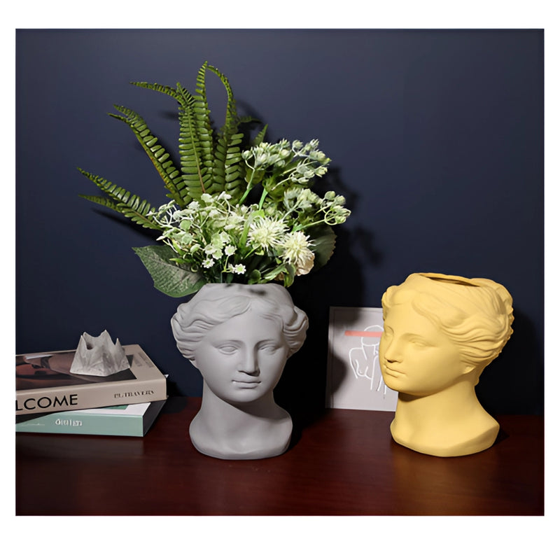 Resin Neoclassical Venus vase in blush pink, teal, and grey, featuring a detailed design that includes elements resembling plants and artistic embellishments, suitable for use as a flowerpot.