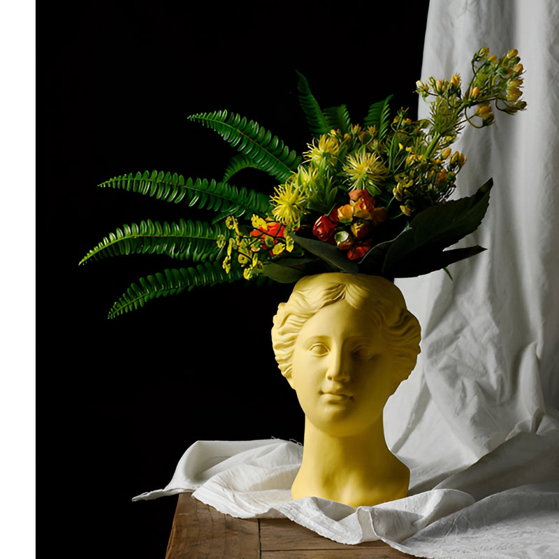 Resin Neoclassical Venus Vase featuring a sculpture of Venus adorned with a bouquet of artificial flowers and petals in a flower arranging art style.