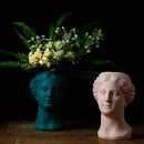 Resin neoclassical Venus vase featuring a blend of sculpture and floral arrangement, crafted in natural material. Ideal for flower arranging, it accentuates any space with its artistic and elegant design.