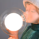 Resin table lamp featuring a design of an elegant rabbit girl, with a dual glass lampshade and detailed embellishments suggestive of light and decorative elements, set on a wooden base.