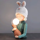 Resin table lamp featuring an elegance rabbit girl design, with a dual glass lampshade and details including a cap and costume hat.