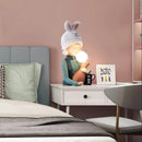 Resin table lamp featuring an elegant rabbit girl design with dual glass lampshades, set on a wooden table in a well-lit interior.