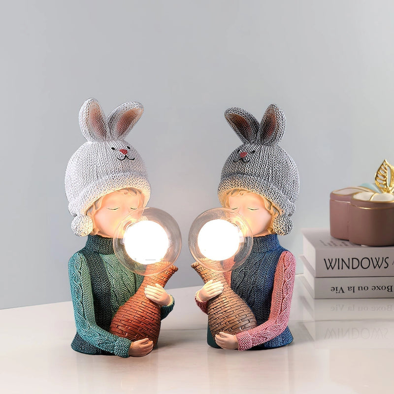 Resin table lamp featuring an elegant rabbit girl design with dual glass lampshades, surrounded by toys and fashion accessories in a room setting.